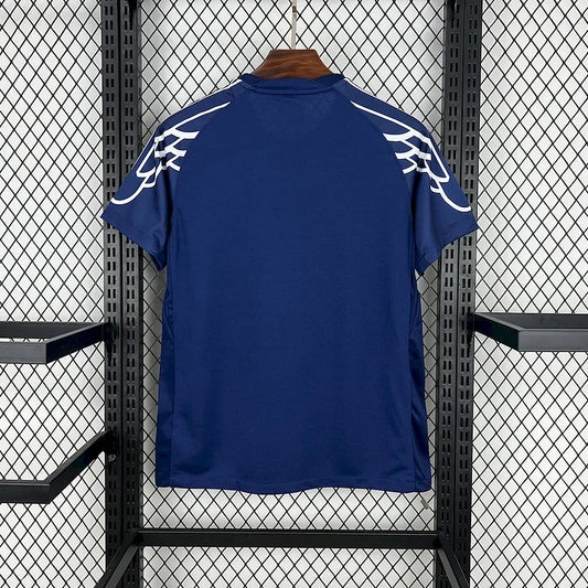 Maillot PSG 2025-2026 quatrième bleu marine avec motifs blancs aux épaules sur cintre