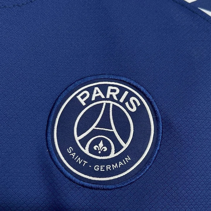 Logo brodé du club de football Paris Saint-Germain sur maillot bleu